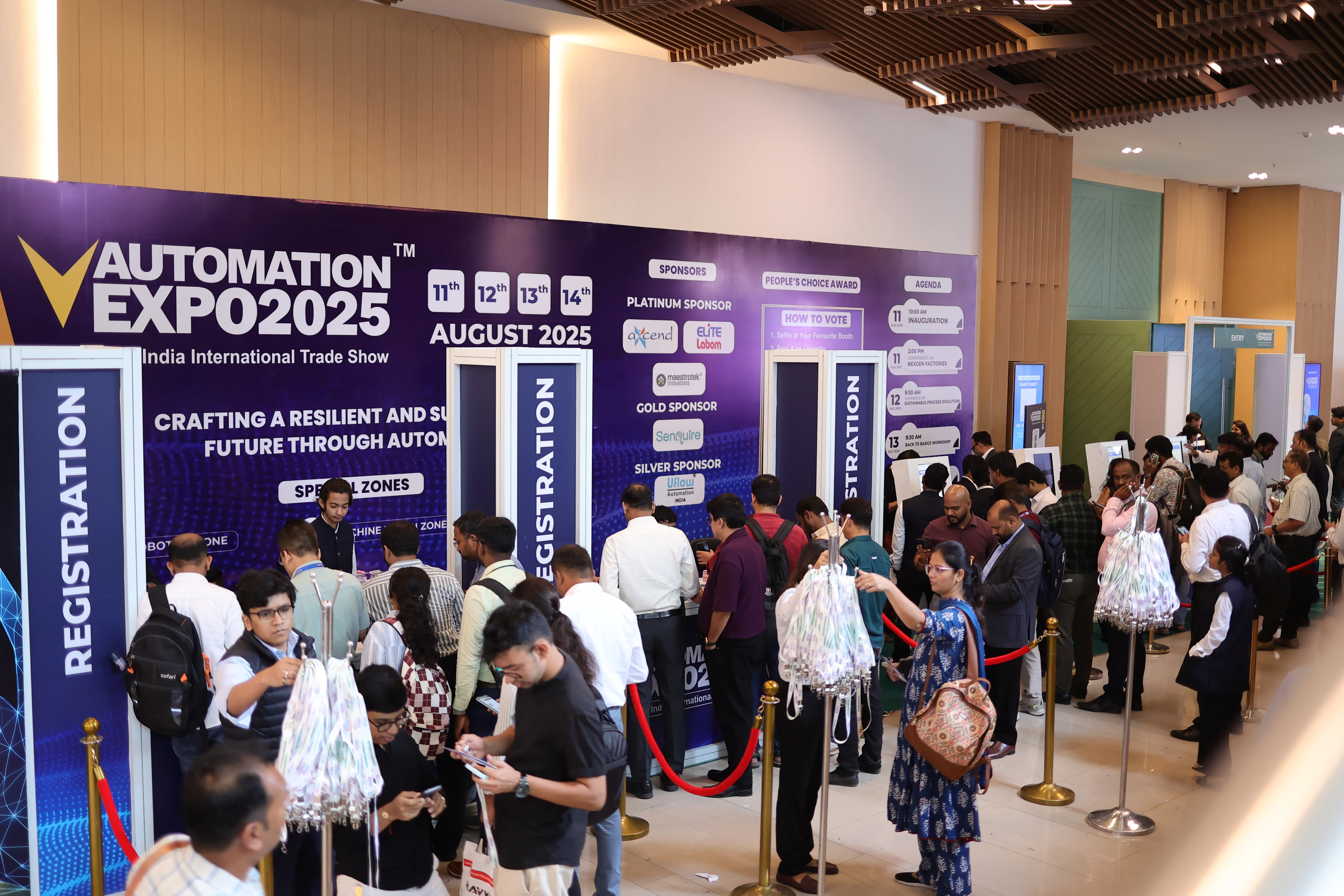 Visitors queued at the registration desk at a past Automation Expo
