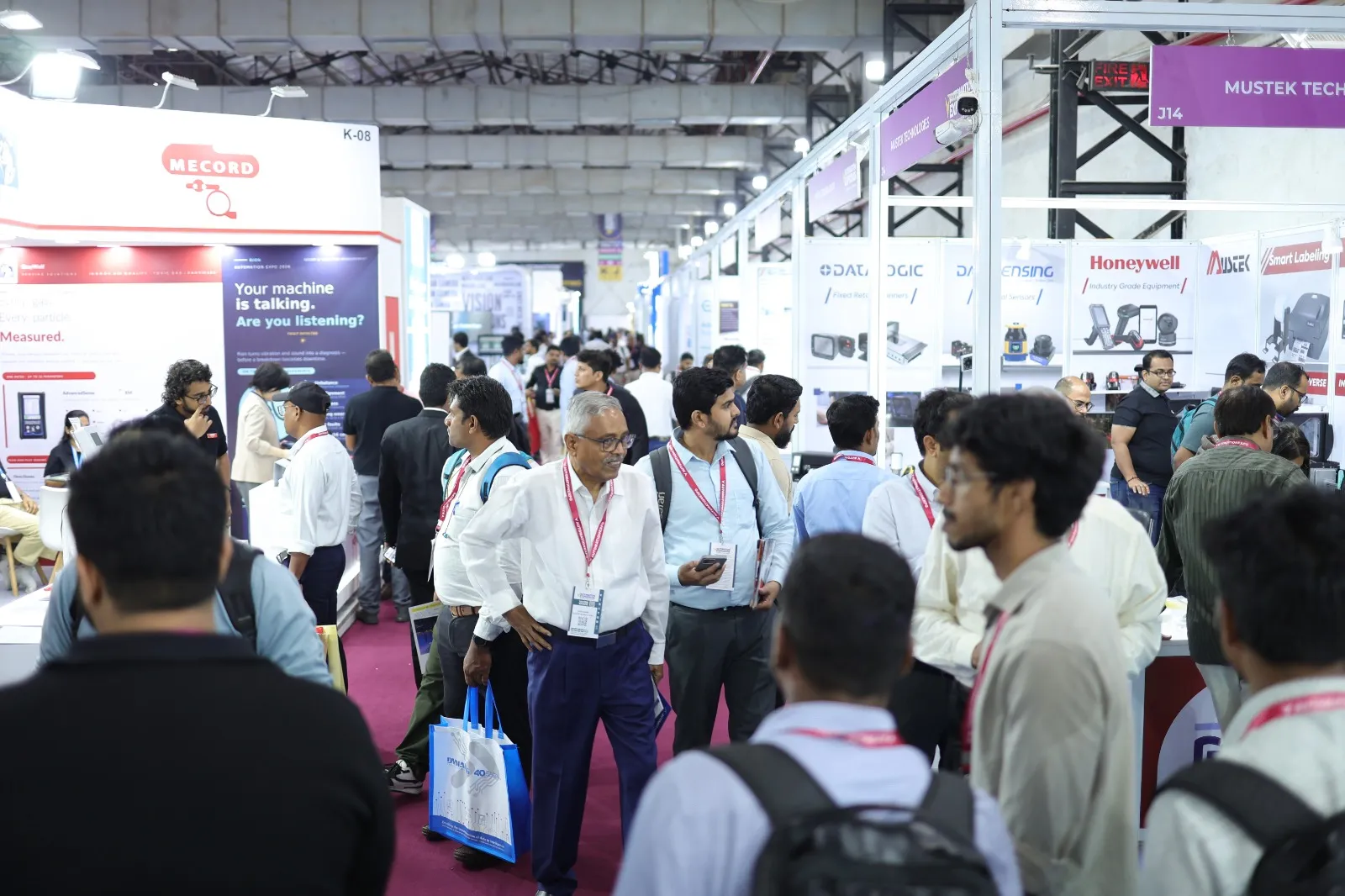 Visitors walking the aisles between exhibitor stands at a past Automation Expo